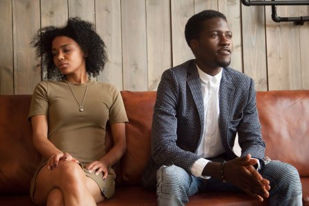 young black couple arguing on sofa