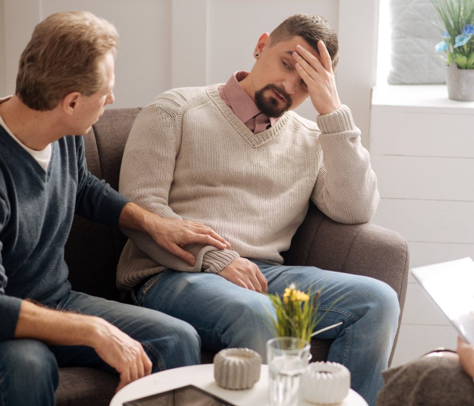 middle-aged white male gay couple in counseling session