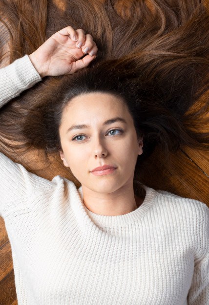 Individual Counseling – young woman laying on floor pondering life young woman laying on floor pondering life