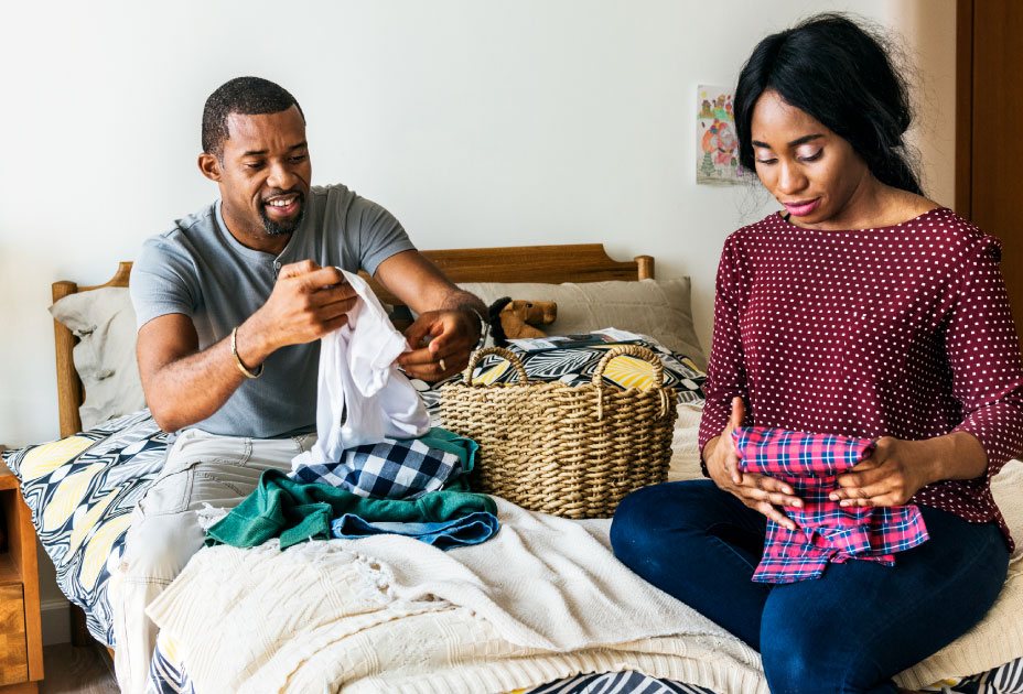 Black couple folding clothes together