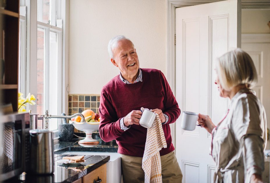 Happy White Elderly Couple In The Kitchen