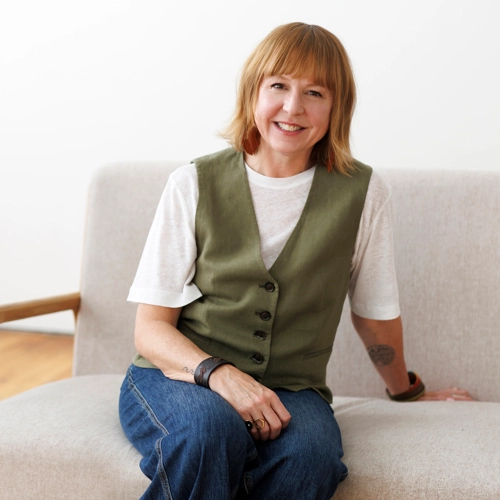 Kate Engler sitting on a couch and smiling